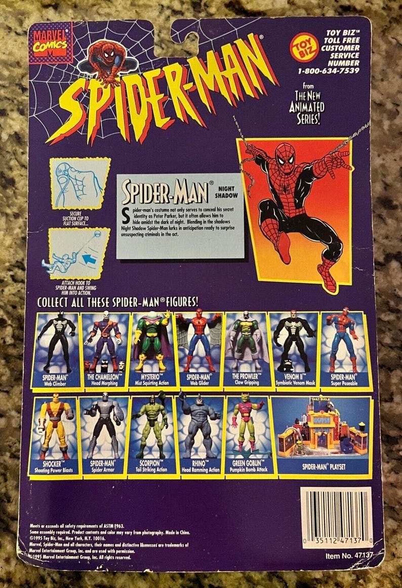 May include: A Spider-Man action figure from the animated series. The figure is posed in a dynamic action pose with its arms outstretched. The figure is red and blue with a black spider symbol on its chest. The figure is packaged on a blue and purple card with a picture of Spider-Man in the background. The card also features a description of the figure and a list of other Spider-Man figures.