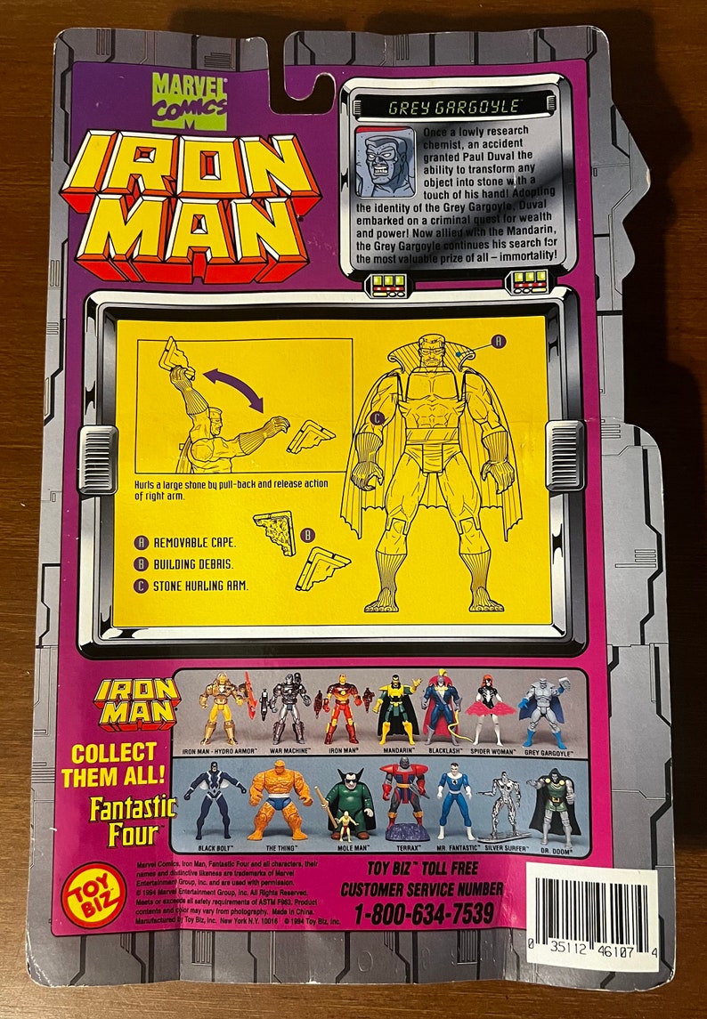 May include: A plastic action figure of Grey Gargoyle from the Marvel Comics series Iron Man. The figure is posed with a removable cape, building debris, and a stone-hurling arm. The figure is part of a larger collection of Marvel Comics characters.