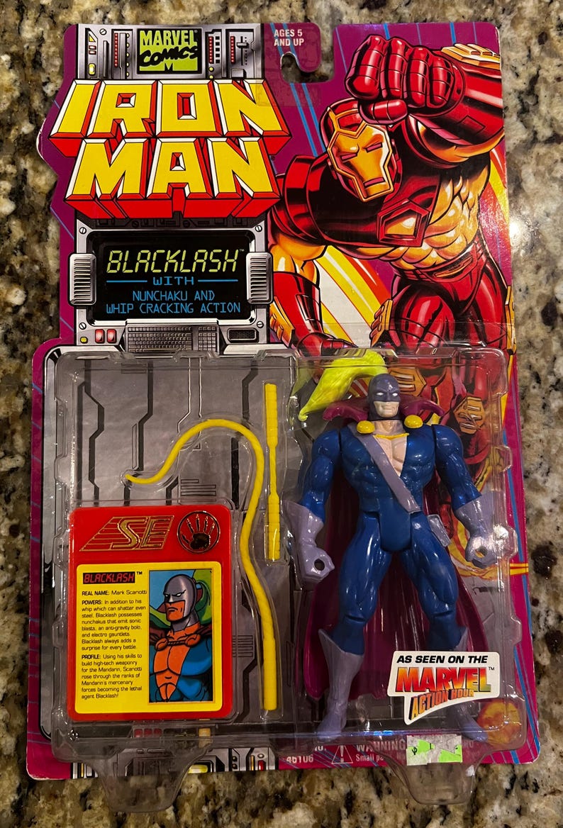May include: Iron Man Blacklash action figure in original packaging. The figure is blue, purple, and yellow, with a cape and whip. The packaging features the Marvel Comics logo and the text "Blacklash with Nunchaku and Whip Cracking Action."