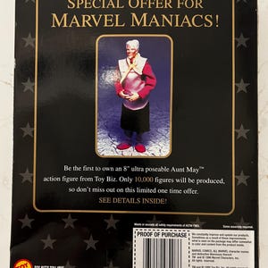 May include: Aunt May action figure from Toy Biz. The packaging features the text "SPECIAL OFFER FOR MARVEL MANIACS!" and "Be the first to own an 8" ultra poseable Aunt May action figure." The box is black with gold accents and star patterns.