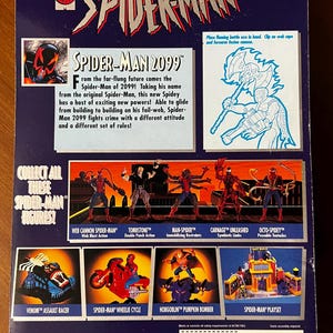 May include: Back of a Spider-Man 2099 action figure package. The package is blue and features a red Spider-Man logo. The back of the package shows different Spider-Man characters and playsets. The text on the back of the package reads "The Amazing Spider-Man" and "Spider-Man 2099".