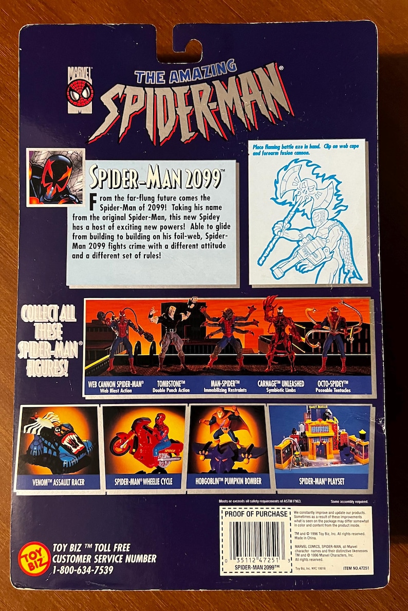 May include: Back of a Spider-Man 2099 action figure package. The package is blue and features a red Spider-Man logo. The back of the package shows different Spider-Man characters and playsets. The text on the back of the package reads "The Amazing Spider-Man" and "Spider-Man 2099".