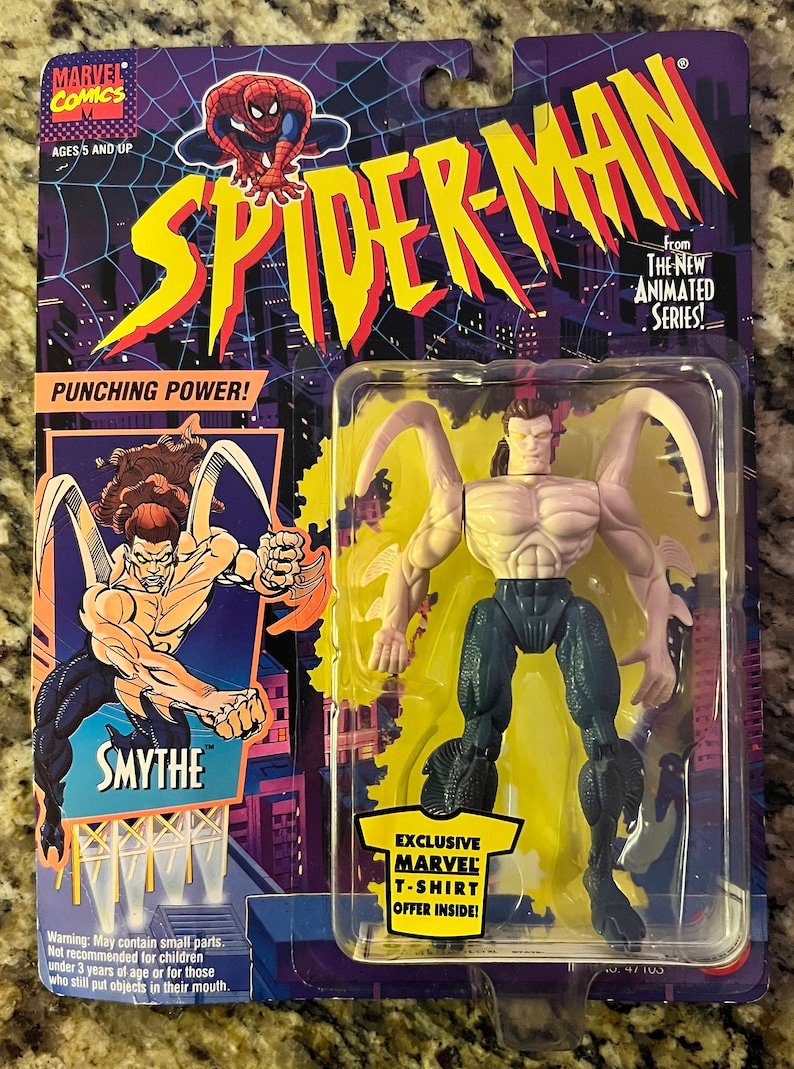 May include: A Spider-Man action figure from the 1990s, with a purple and white body, blue pants, and black claws. The figure is packaged in a plastic blister pack with a yellow background and the words "Punching Power!" and "Smythe" on the front. The figure is from the "The New Animated Series!" line of toys.