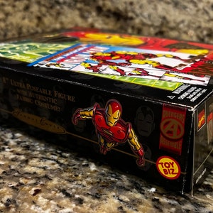 May include: A black box with a red and yellow Iron Man figure on the front. The box says "The Incredible Iron Man" and "8" Ultra Poseable Figure with Authentic Fabric Costume!" on the side. The box also has the Toy Biz logo.