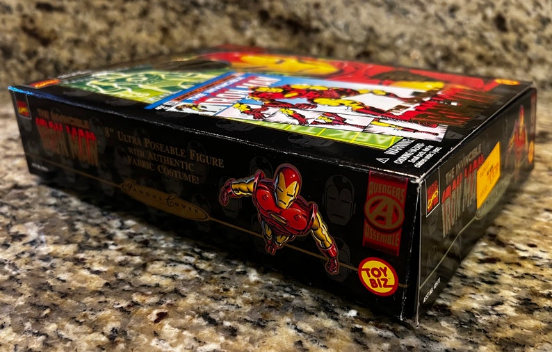 May include: A black box with a red and yellow Iron Man figure on the front. The box says "The Incredible Iron Man" and "8" Ultra Poseable Figure with Authentic Fabric Costume!" on the side. The box also has the Toy Biz logo.