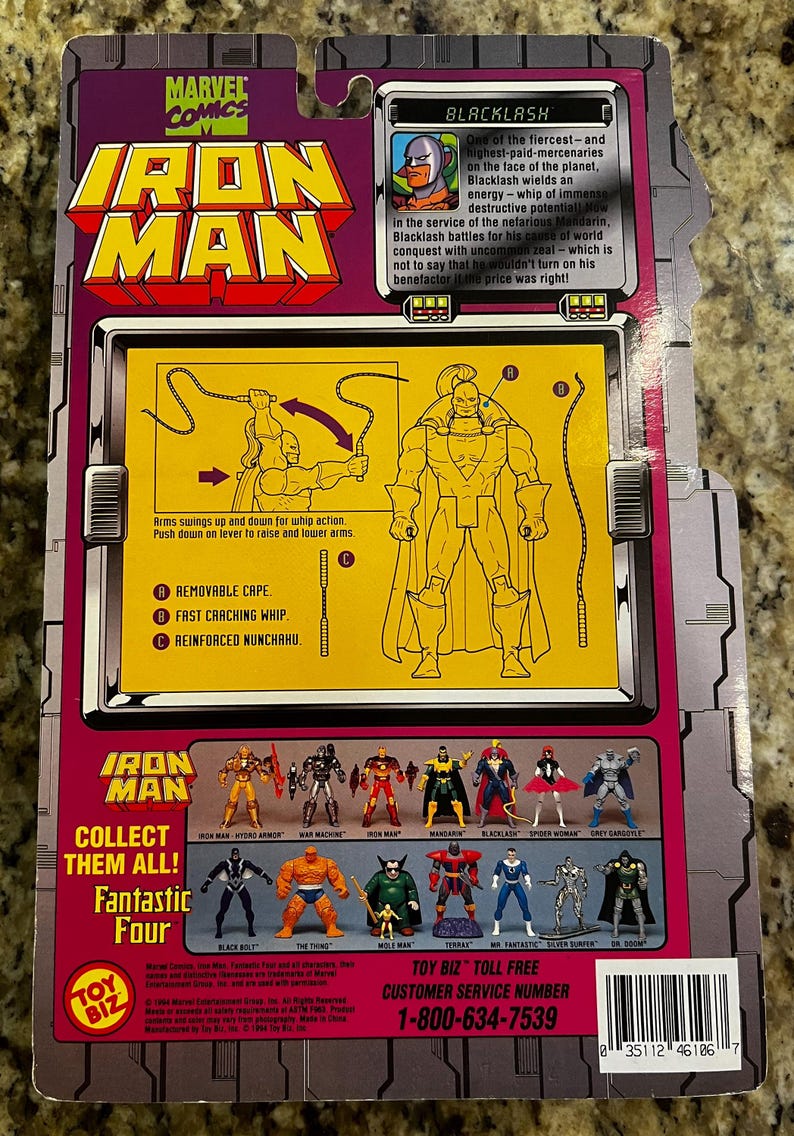 May include: Back of an Iron Man action figure package featuring Blacklash. The package has a purple and yellow color scheme with illustrations of the character and other figures. Includes the text "Collect Them All! Fantastic Four."