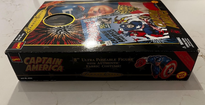 May include: A black box featuring Captain America graphics, including comic book art and the character's image. The box reads "CAPTAIN AMERICA" and "8" Ultra Poseable Figure with Authentic Fabric Costume!"