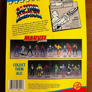 May include: Back of a vintage Marvel Super Heroes Captain America action figure package. The package features illustrations of various Marvel characters, including Spider-Man, Venom, and Mr. Fantastic. The text reads "Collect Them All!"