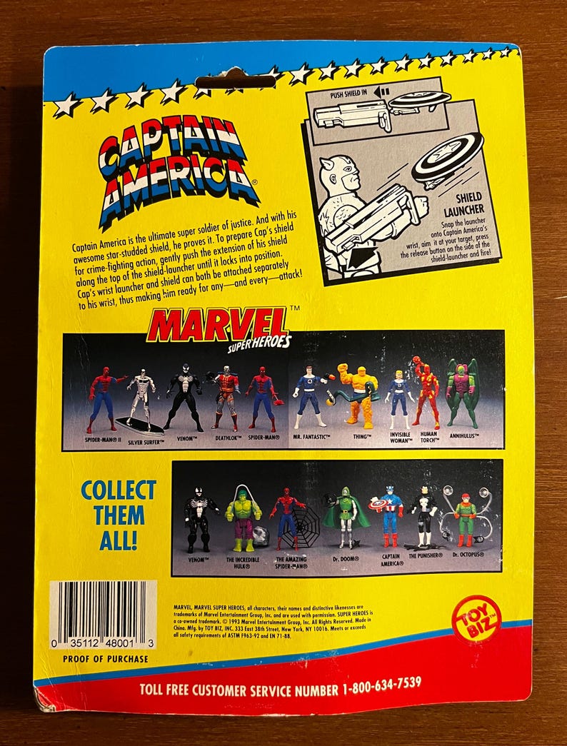 May include: Back of a vintage Marvel Super Heroes Captain America action figure package. The package features illustrations of various Marvel characters, including Spider-Man, Venom, and Mr. Fantastic. The text reads "Collect Them All!"