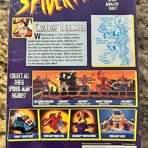 May include: Back of a packaging box for a Carnage Unleashed action figure from the Spider-Man animated series. The box features a red and black illustration of Carnage with a description of the character. The box also features images of other Spider-Man action figures, including Venom, Tombstone, and Man-Spider.