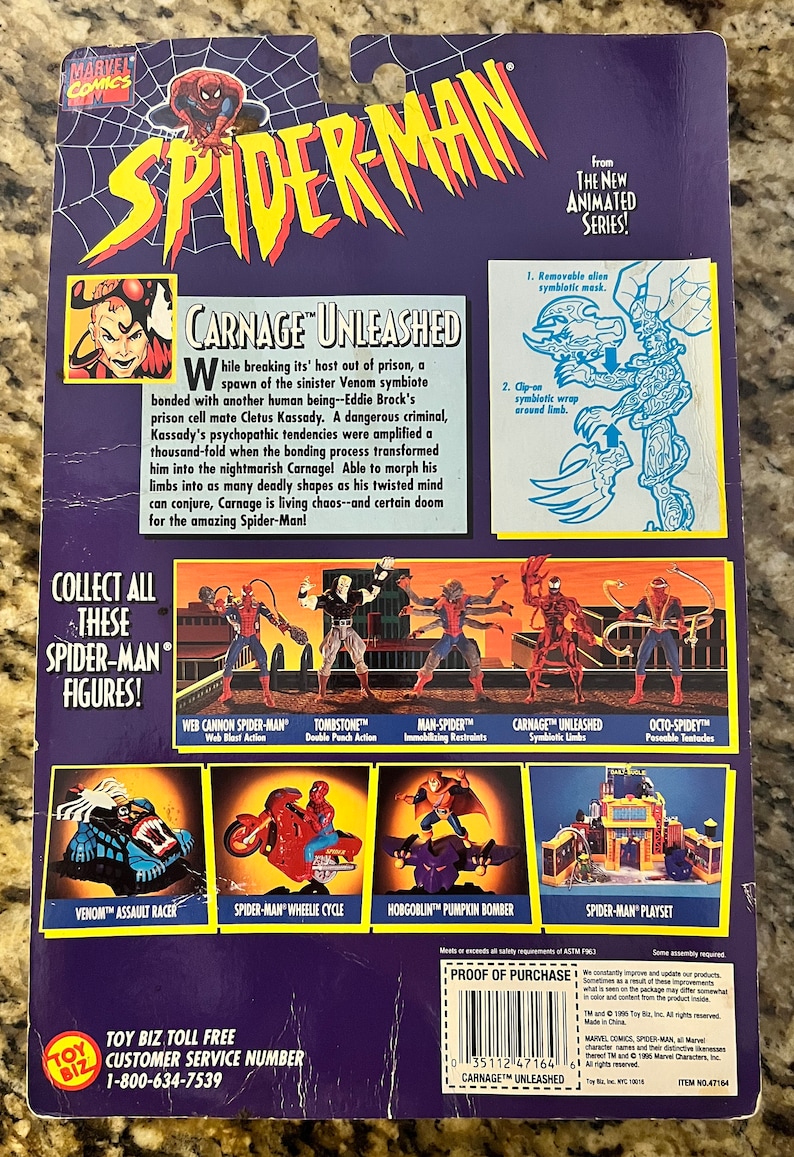 May include: Back of a packaging box for a Carnage Unleashed action figure from the Spider-Man animated series. The box features a red and black illustration of Carnage with a description of the character. The box also features images of other Spider-Man action figures, including Venom, Tombstone, and Man-Spider.