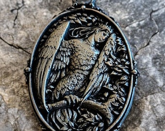 The Bird of Sorrow: white brass pendant