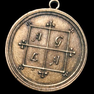 May include: A round, bronze pendant with a square design featuring the letters 'I', 'G', 'L', and 'I' in a grid pattern. The pendant has a loop at the top for hanging.