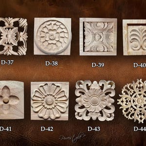 May include: A collection of eight intricately carved wooden decorative elements. Each piece features a unique floral or geometric design, with the product codes D-37 through D-44 visible. The carvings are displayed against a brown background.