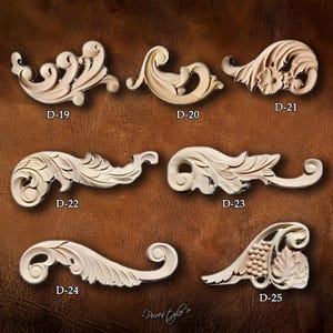 May include: A collection of seven intricately carved wooden decorative elements, each with a unique scroll and leaf design. The pieces are labeled D-19 through D-25 and are displayed against a brown background.
