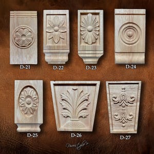 May include: Seven wooden architectural decorative elements with carved designs. The designs include floral patterns, geometric shapes, and stylized leaves. Each piece is labelled with a "D" followed by a number. The text "Pures Ly" is also visible.