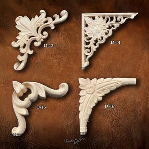 May include: Four decorative wooden corner brackets with floral and scroll designs. Each bracket is a different shape and features intricate carvings. The brackets are labeled D-13, D-14, D-15, and D-16.