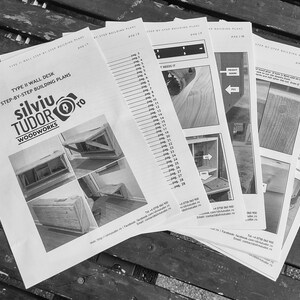 May include: Black and white photo of a set of instructions for building a wall desk. The instructions are titled "Type II Wall Desk Step-by-Step Building Plans" and feature the logo "silviu TUDOR WOODWORKS".