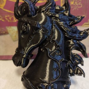 May include: A black 3D printed horse head sculpture with intricate details and a textured finish.
