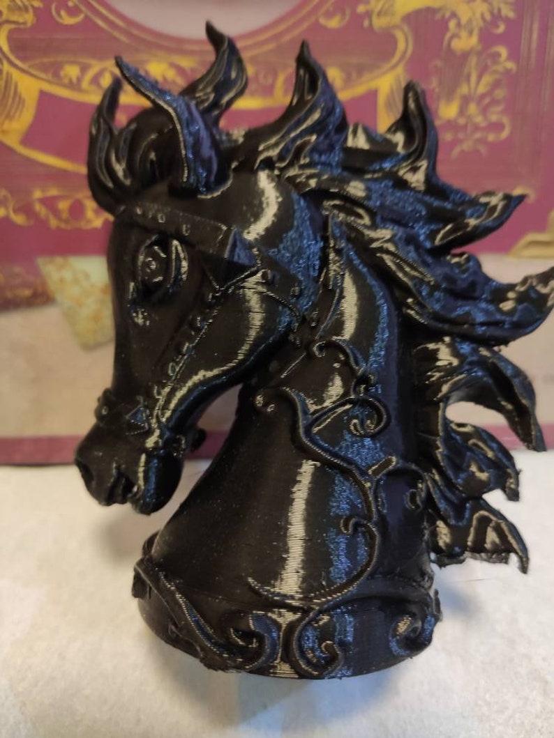 May include: A black 3D printed horse head sculpture with intricate details and a textured finish.