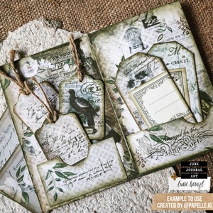 May include: A green and brown scrapbook with various paper tags and embellishments. The tags have handwritten text and floral designs. The scrapbook is decorated with a twine bow and a small bird charm. The text "Arranged for the" is visible on the scrapbook.