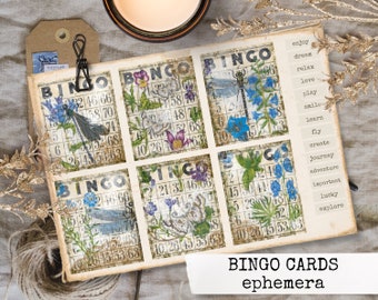 May include: Six vintage-style bingo cards with floral and dragonfly designs. Each card has a grid with numbers and a free space in the center. The cards are printed on aged paper with a distressed look. The text "BINGO CARDS ephemera" is printed below the cards.