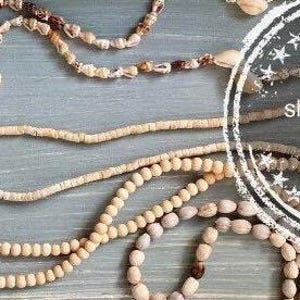 May include: A collection of natural wood bead necklaces with a white circle stamp that says "shop Lovefind on Etsy".