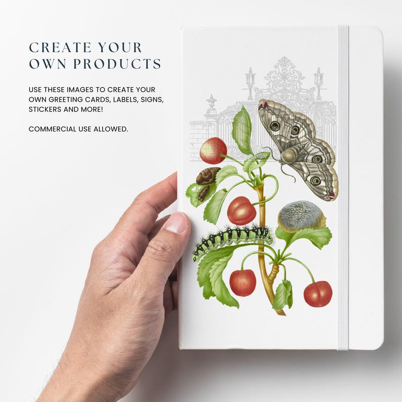 May include: A white notebook with a black and white illustration of a butterfly, a caterpillar, and cherries on a branch. The text "CREATE YOUR OWN PRODUCTS" is at the top of the notebook. The text "USE THESE IMAGES TO CREATE YOUR OWN GREETING CARDS, LABELS, SIGNS, STICKERS AND MORE!" is below the illustration. The text "COMMERCIAL USE ALLOWED." is at the bottom of the notebook.