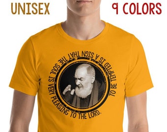 May include: Mustard yellow unisex t-shirt with a circular graphic featuring a black and white portrait and the text "TO BE TEMPTED IS A SIGN THAT THE SOUL IS VERY PLEASING TO THE LORD." The shirt also has the text "9 COLORS".