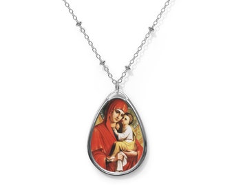 May include: Silver chain necklace with a teardrop-shaped pendant featuring a colorful image of the Virgin Mary holding a baby Jesus.
