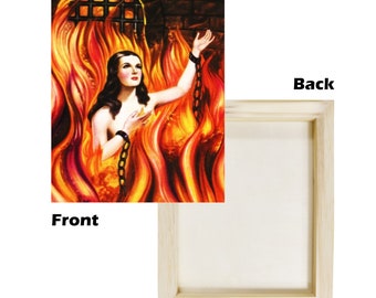 May include: A framed canvas print of a woman in flames. The woman is wearing chains and is looking up. The flames are orange, yellow, and red. The background is dark.