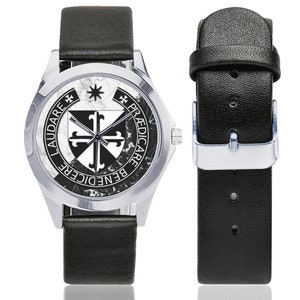 May include: A silver-toned wristwatch with a black leather band. The watch face features a black and white emblem with the words "LAUDARE BENEDICERE PREDICARE". The watch band is shown separately with a silver buckle.
