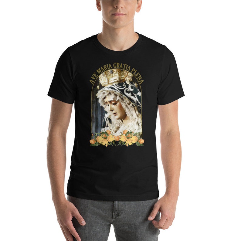 May include: Black t-shirt with a religious image of a woman in a crown and veil, with yellow roses. The text "AVE MARIA GRATIA PLENA" is arched above the image in gold lettering.