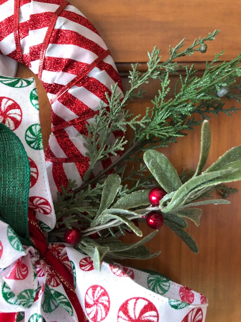 Handcrafted Red /& White Christmas Candy Cane Wreath Decorated with a Accent Bow and Greenery Accents