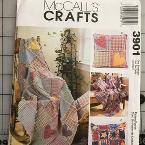 May include: McCall's Crafts pattern envelope featuring a patchwork quilt and pillow designs. The quilt has heart appliqués and the pillows have star and heart designs. The envelope includes the number 3901.