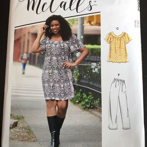 May include: A McCall's sewing pattern package featuring a woman in a patterned dress. The package includes illustrations of a top and pants. The text on the package reads "McCall's" and "#RosieMcCalls".