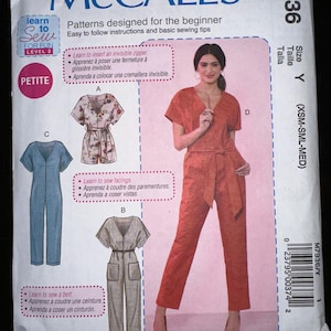 May include: A McCall's sewing pattern for beginners, featuring a petite jumpsuit design. The pattern includes instructions for an invisible zipper, facings, and a belt. The cover shows a woman in a red jumpsuit.
