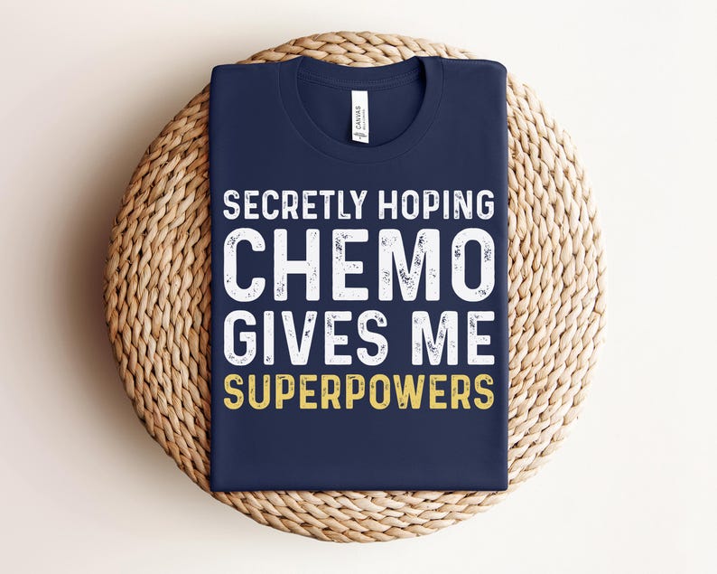 May include: A navy blue t-shirt with white text that reads "Secretly Hoping Chemo Gives Me Superpowers".