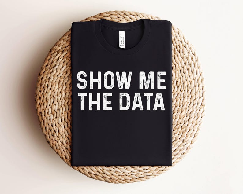 May include: Black t-shirt with white text that reads "Show Me The Data".