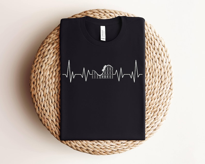 May include: Black t-shirt with a white graphic of a roller coaster inside a heartbeat. The graphic is a simple line drawing.