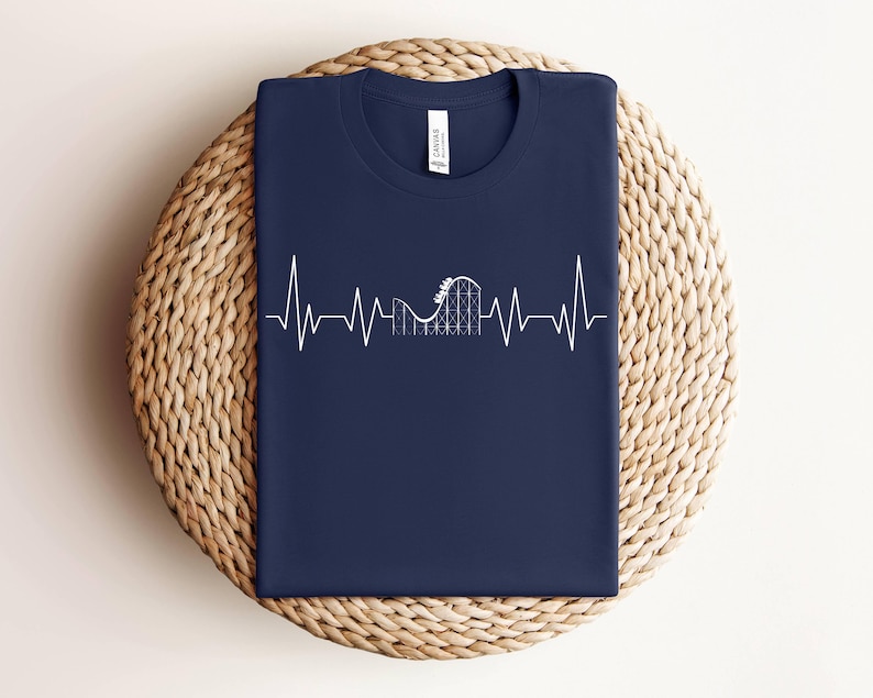 May include: A navy blue t-shirt with a white graphic of a roller coaster inside a heartbeat.