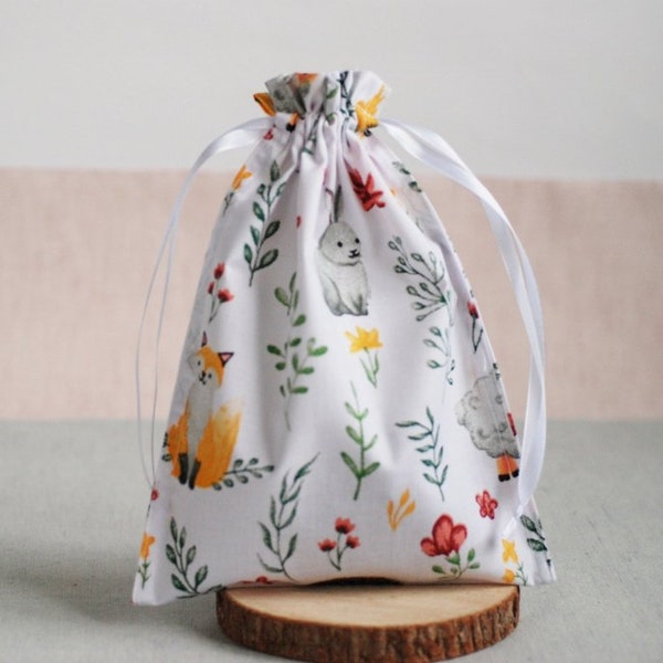 White cotton drawstring bag with printed animals fox rabbit hedgehog wild flowers