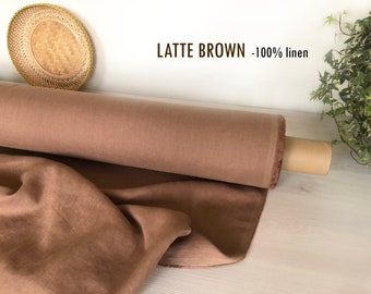 May include: A roll of brown linen fabric, 100% linen, labeled "LATTE BROWN - 100% linen".