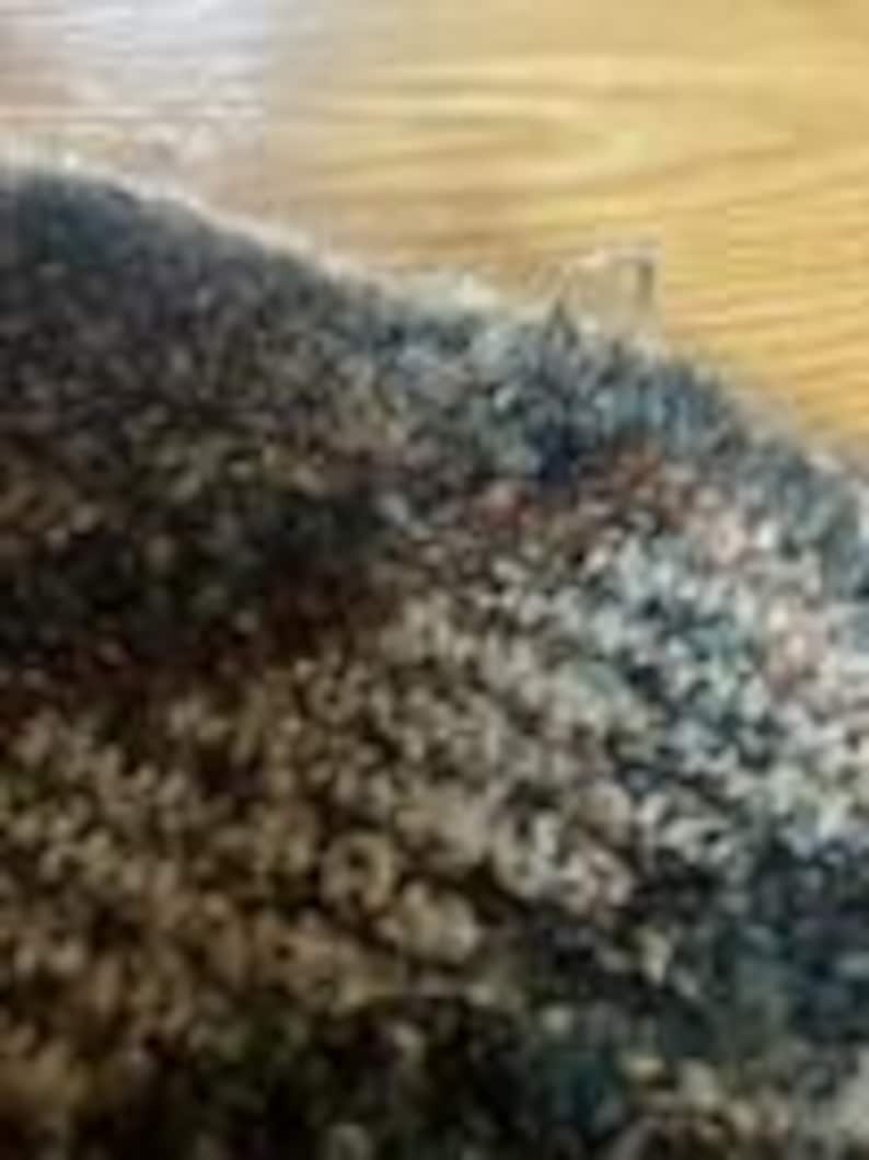 May include: A close-up view of a thick, textured knit fabric featuring a variegated color palette of charcoal gray, deep navy blue, and soft cream tones. The material displays a dense, looped yarn construction with a fuzzy, multi-dimensional surface.