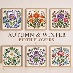 May include: Six framed cross-stitch artworks featuring floral designs in various colors. The artworks are in wooden frames and are arranged on a wall. The text "AUTUMN & WINTER BIRTH FLOWERS" is displayed below the artworks.
