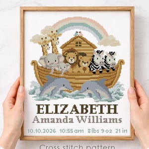 May include: Cross-stitch pattern featuring Noah's Ark with animals, a rainbow, and dolphins. The design includes the name "ELIZABETH Amanda Williams" and birth details: 10.10.2026, 10:55 am, 8 lbs 9 oz, and 21 inches. The text "Cross stitch pattern Instant download PDF" is also included.