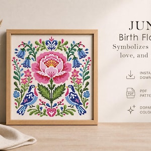 May include: A framed cross-stitch pattern featuring a large pink flower, blue birds, and floral elements. The text reads "JUNE Birth Flowers" and "Symbolizes romance, love, and passion." The design is in a wooden frame.