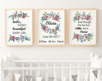 May include: Three framed prints with floral designs and text. The first print says "hello, sweet beautiful baby girl". The second print says "Olivia" with the date "June 23, 2017" and the time "10:55 am 8lb 9oz 2linch". The third print says "And though she be but little she is fierce".