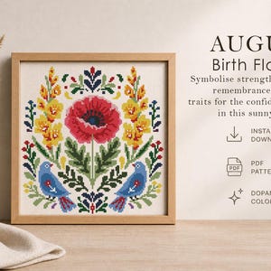 May include: A framed cross-stitch design featuring a central red poppy, surrounded by yellow and green floral elements, and two blue birds. The text "AUGUST Birth Flowers" is displayed above the design. The design is in a wooden frame.