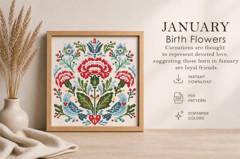 May include: A framed cross-stitch pattern featuring a floral design with red carnations, blue birds, and green leaves. The text "JANUARY Birth Flowers" is displayed, along with the phrase "Carnations are thought to represent devoted love."